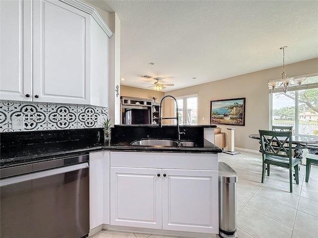 kitchen with sink, stainless steel dishwasher, kitchen peninsula, decorative backsplash, and white cabinets