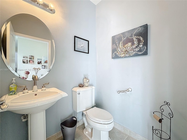 bathroom featuring tile patterned flooring and toilet