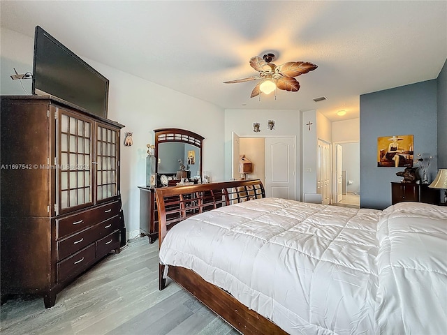 bedroom with light wood-type flooring and ceiling fan