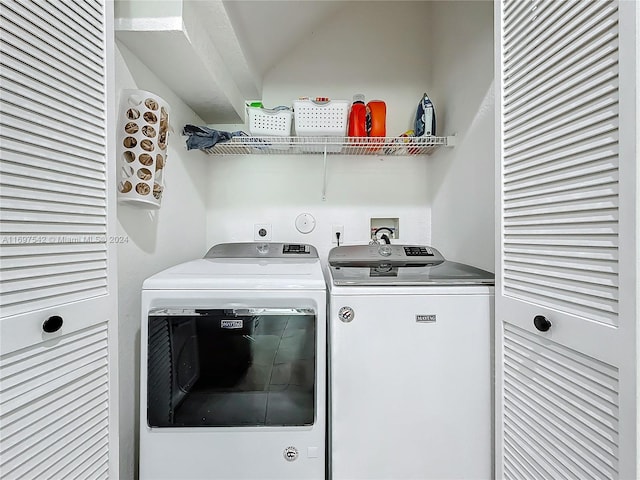 clothes washing area with separate washer and dryer