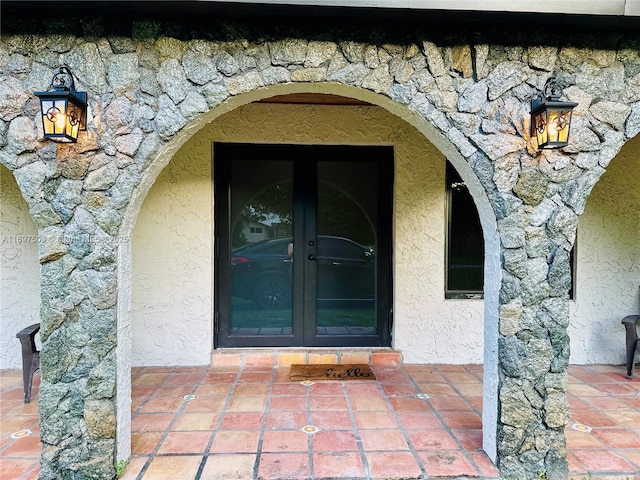 5210 SW 186th Ave, Southwest Ranches, FL 33332 - view of exterior entry with stone siding, french doors, and stucco siding
