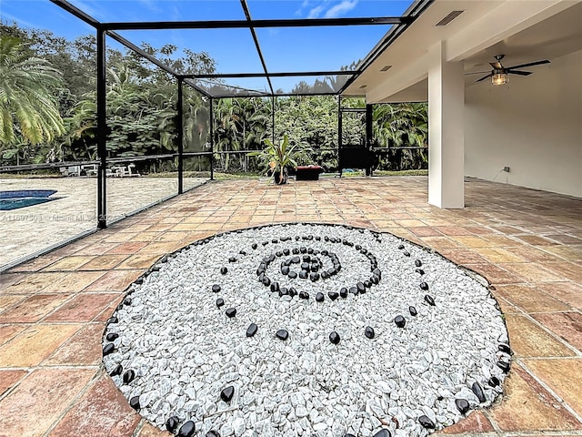 view of patio / terrace featuring ceiling fan and a lanai