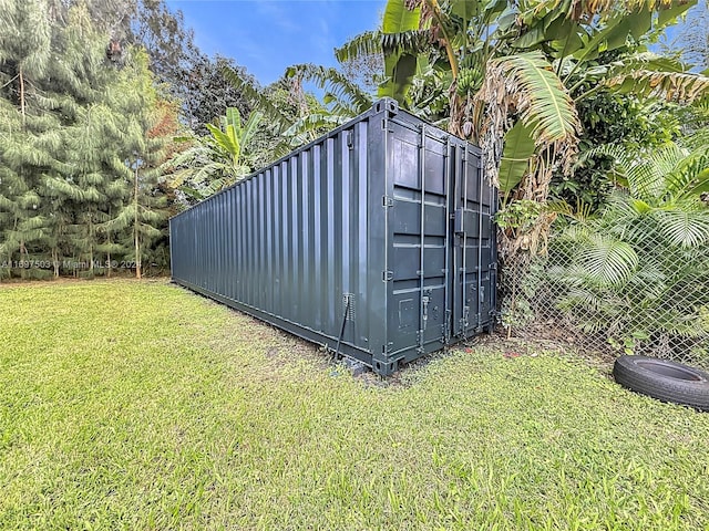 view of outbuilding featuring a yard