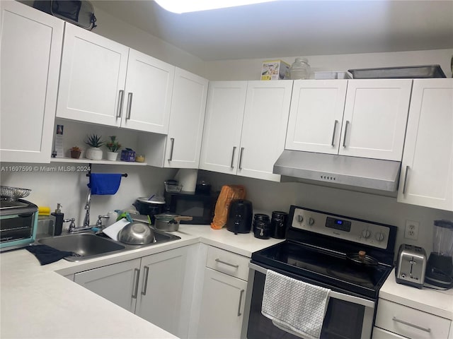 kitchen with white cabinetry, sink, and stainless steel electric range