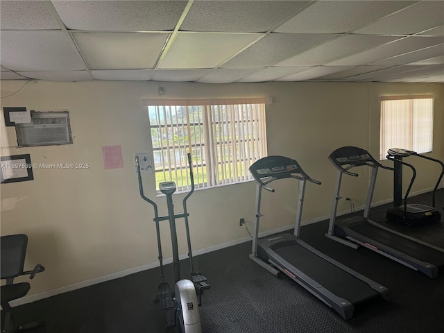 20320 NE 2nd Ave Unit 27, Miami Gardens, FL 33179 - exercise area featuring a drop ceiling, baseboards, and a wall unit AC