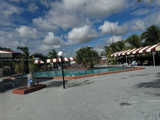 20320 NE 2nd Ave Unit 27, Miami Gardens, FL 33179 - community pool with a patio