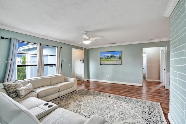 living room with hardwood / wood-style floors, ceiling fan, ornamental molding, and a textured ceiling