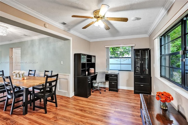 dining space with a textured ceiling, light hardwood / wood-style floors, ceiling fan, and crown molding