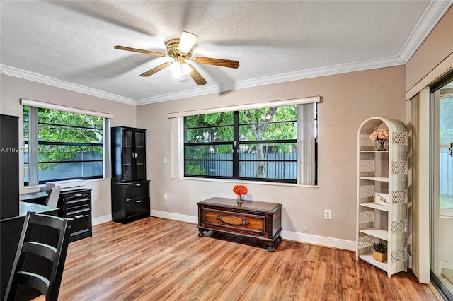 home office featuring a textured ceiling, light wood-type flooring, and ornamental molding