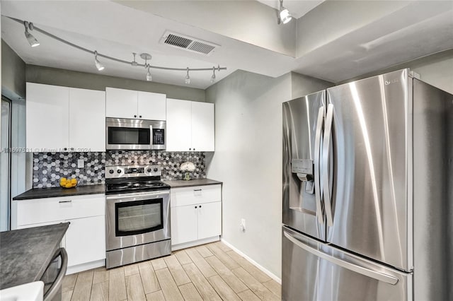 kitchen with decorative backsplash, light wood-type flooring, white cabinetry, and stainless steel appliances