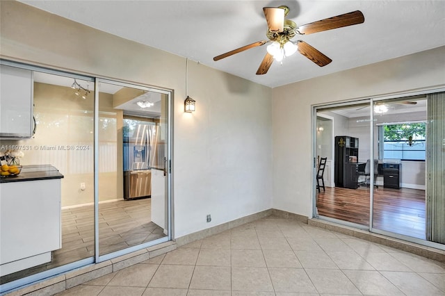 empty room featuring ceiling fan and light hardwood / wood-style floors