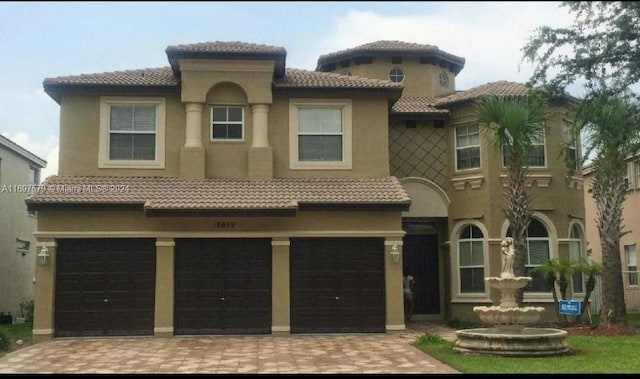 mediterranean / spanish-style house featuring a garage