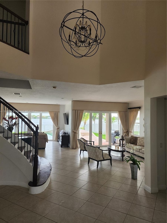 stairs featuring tile patterned floors, french doors, and a high ceiling