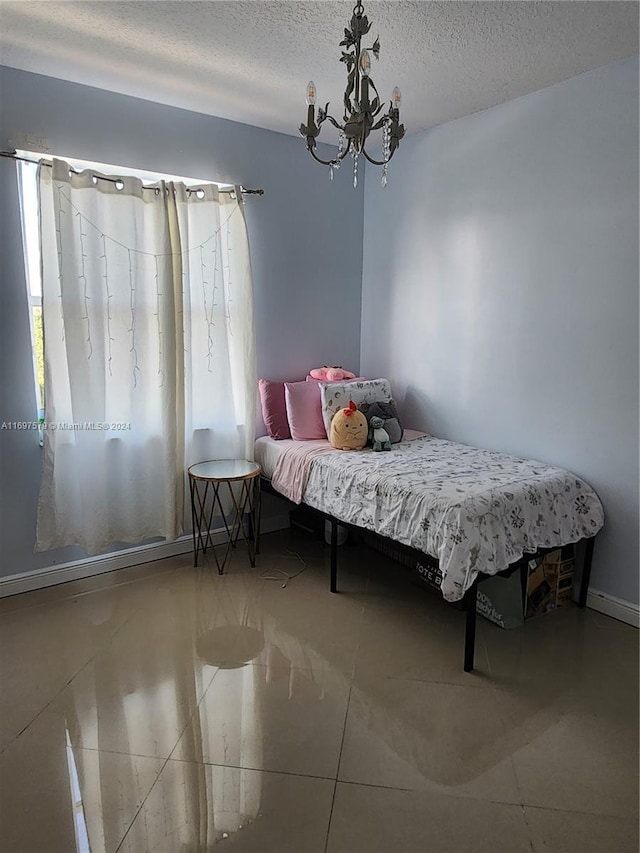 bedroom featuring a textured ceiling and a notable chandelier