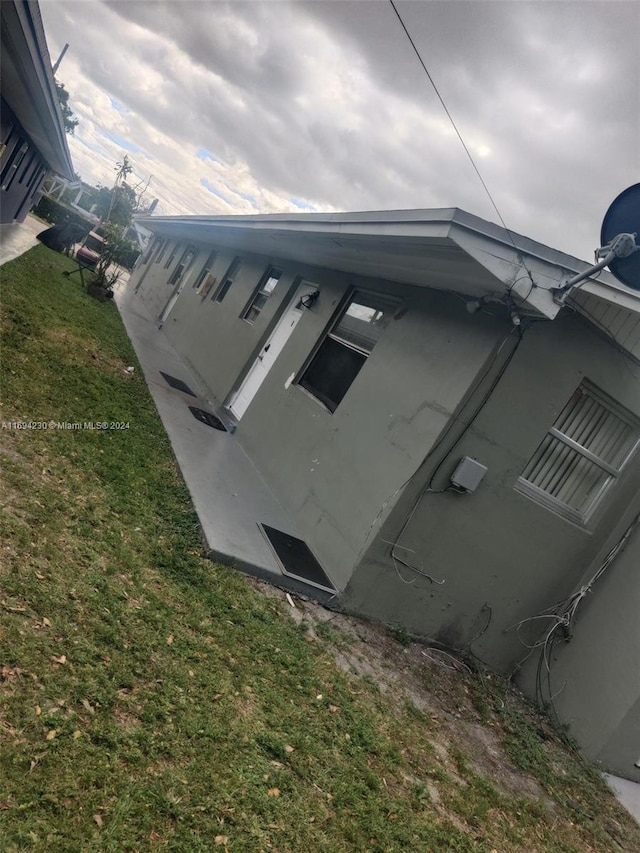 view of storm shelter featuring a lawn