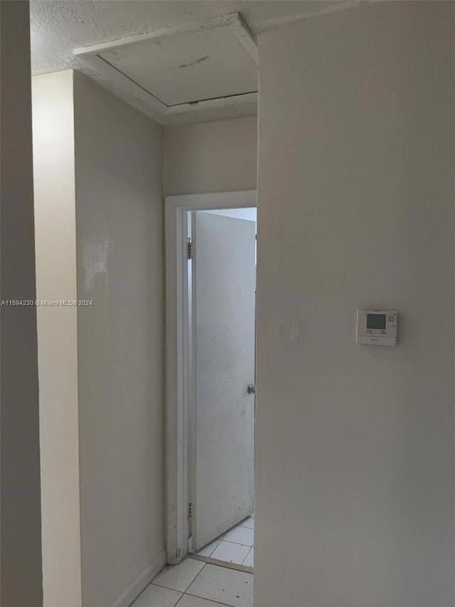 hallway featuring light tile patterned flooring