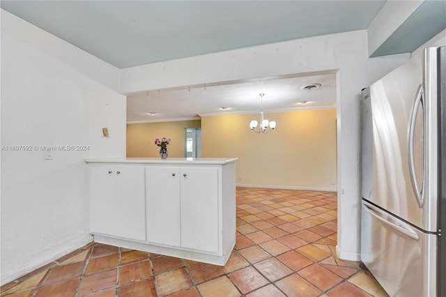 kitchen featuring stainless steel refrigerator, an inviting chandelier, hanging light fixtures, white cabinets, and kitchen peninsula