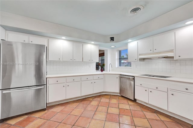 kitchen featuring backsplash, white cabinets, and appliances with stainless steel finishes