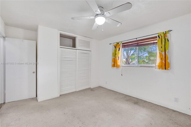 unfurnished bedroom featuring light colored carpet, ceiling fan, and a closet