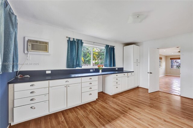 kitchen featuring plenty of natural light, light hardwood / wood-style floors, and white cabinets