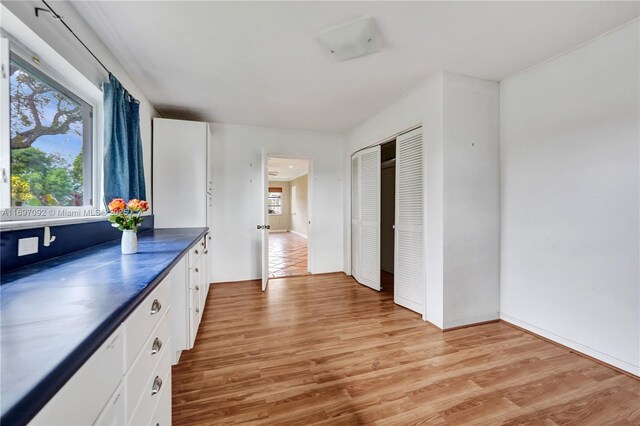 kitchen featuring white cabinetry and light hardwood / wood-style floors