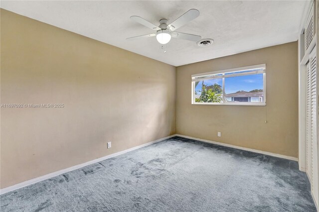 carpeted empty room with ceiling fan