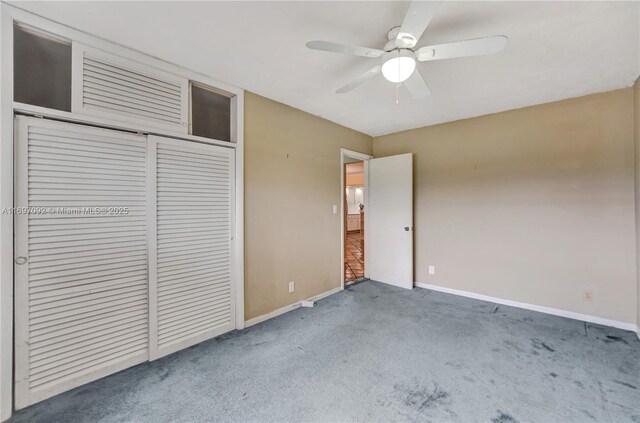 unfurnished bedroom with carpet floors, ceiling fan, and a closet