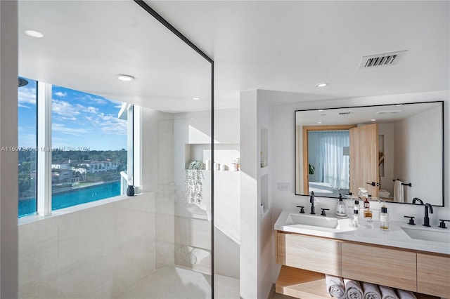 bathroom with walk in shower, vanity, hardwood / wood-style flooring, a water view, and toilet