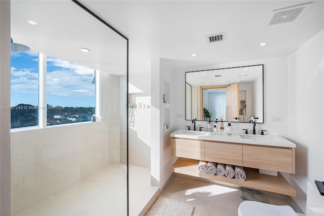 bathroom featuring a tile shower and vanity