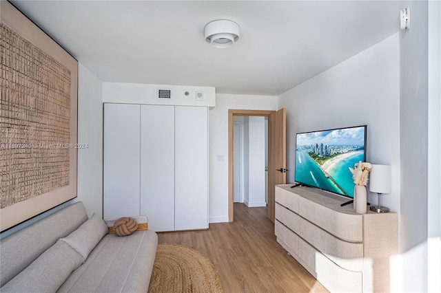 bedroom with light wood-type flooring and a closet