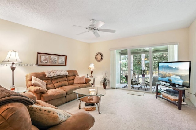 carpeted living room with ceiling fan and a textured ceiling