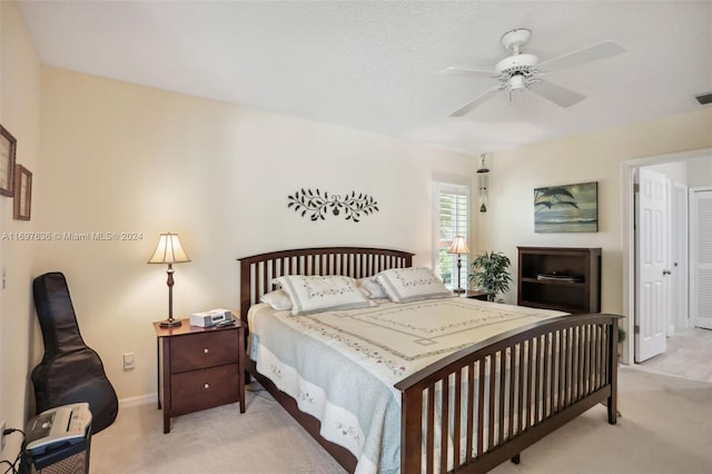 bedroom featuring light carpet and ceiling fan