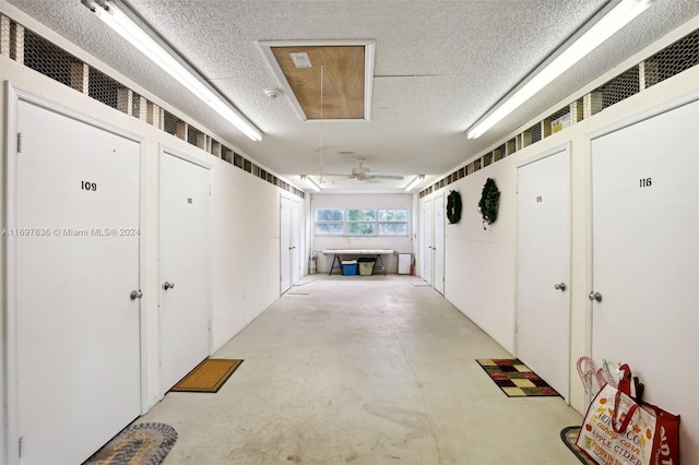 hallway with a textured ceiling