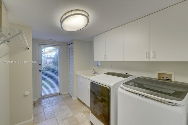 washroom featuring cabinets and washer and dryer