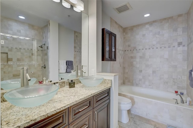 bathroom with tile patterned floors, vanity, and toilet