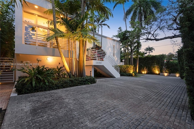 view of property exterior featuring stairway and stucco siding