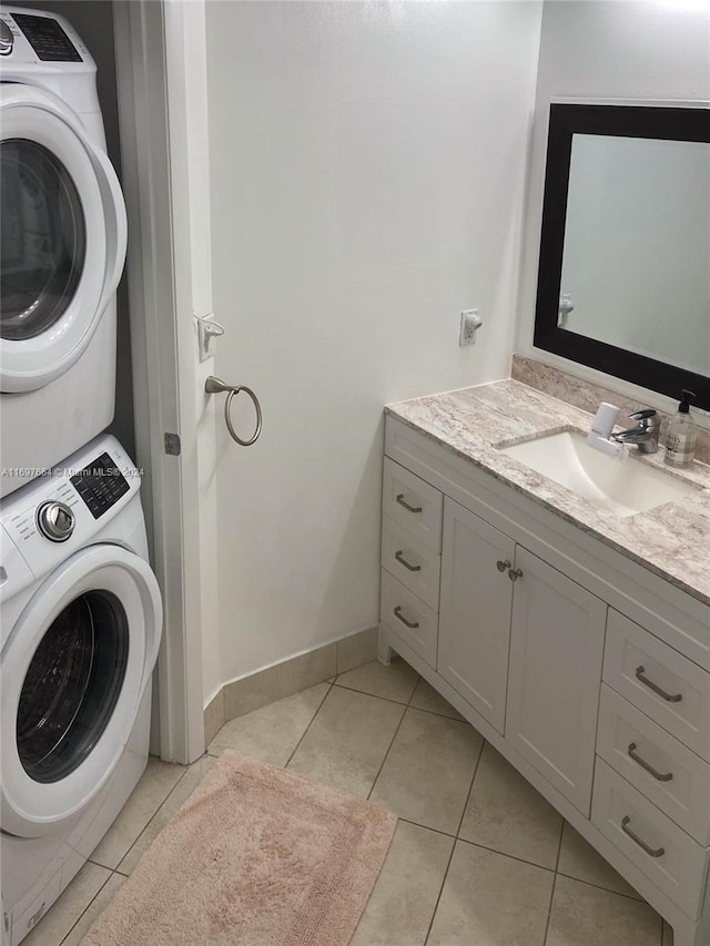 interior space featuring tile patterned flooring, vanity, and stacked washing maching and dryer