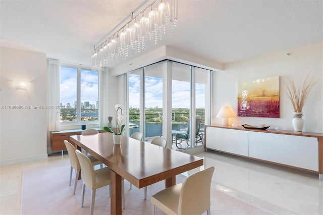 dining space with a notable chandelier and a textured ceiling