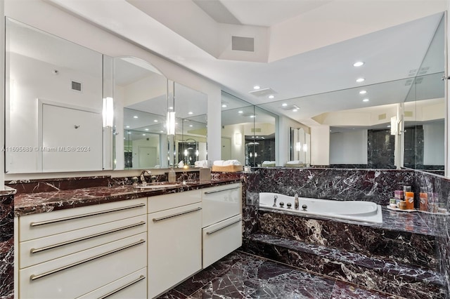 bathroom featuring vanity and independent shower and bath