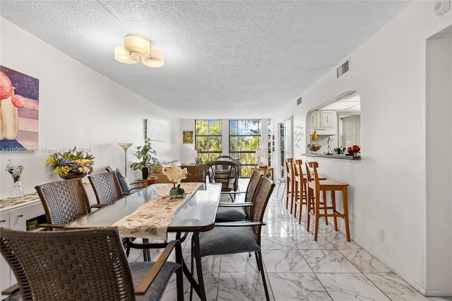 dining area featuring a textured ceiling