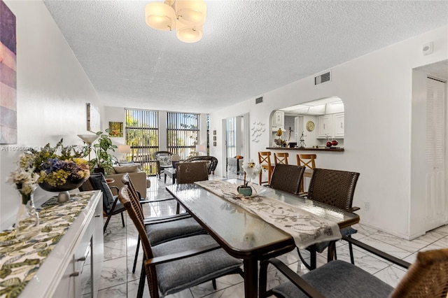 dining room featuring a textured ceiling