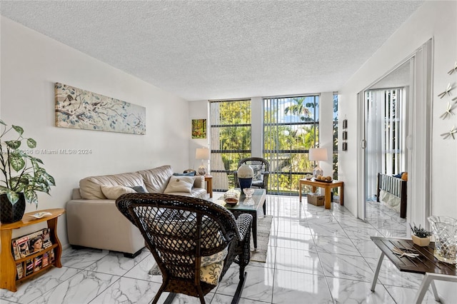 living room with a wall of windows and a textured ceiling