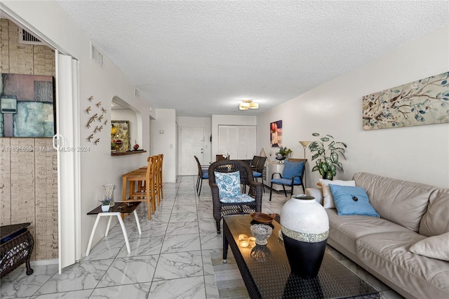 living room featuring a textured ceiling