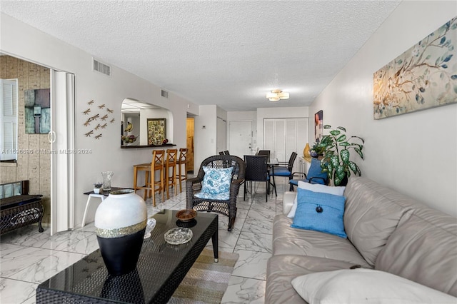 living room with a textured ceiling