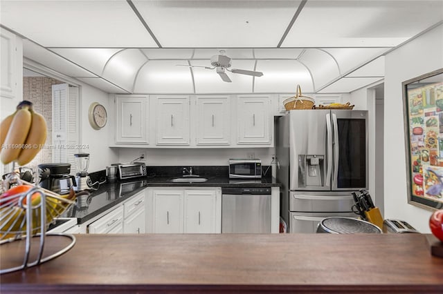 kitchen featuring appliances with stainless steel finishes, white cabinetry, and ceiling fan