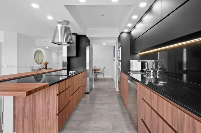 kitchen featuring sink, appliances with stainless steel finishes, and dark stone counters