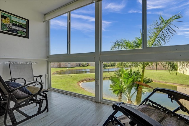 sunroom with plenty of natural light and a water view