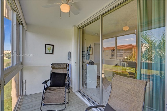 sunroom featuring ceiling fan