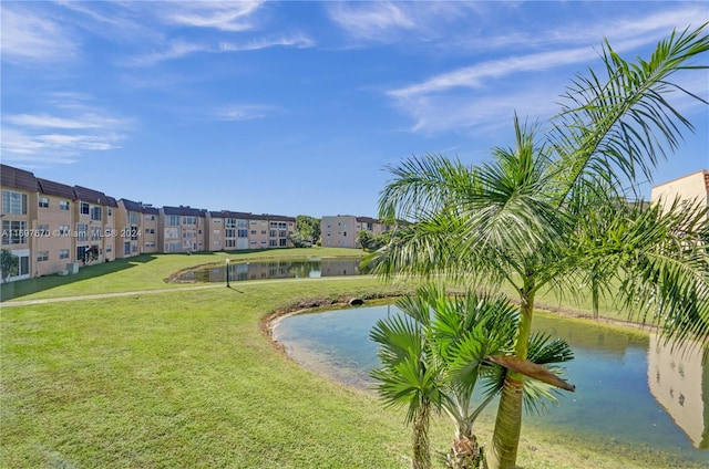 view of property's community featuring a yard and a water view