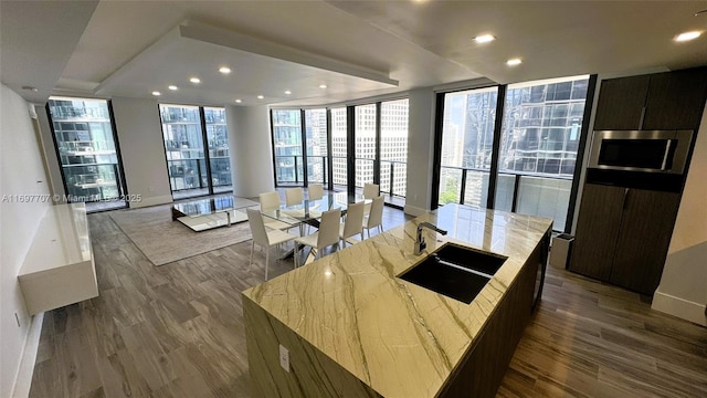 801 S Miami Ave Unit 3205/04, Miami, FL 33130 - kitchen featuring dark wood-style floors, a wall of windows, a sink, and stainless steel microwave